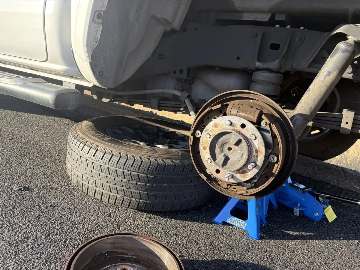 Drum off at the curb, car up on a jack stand.