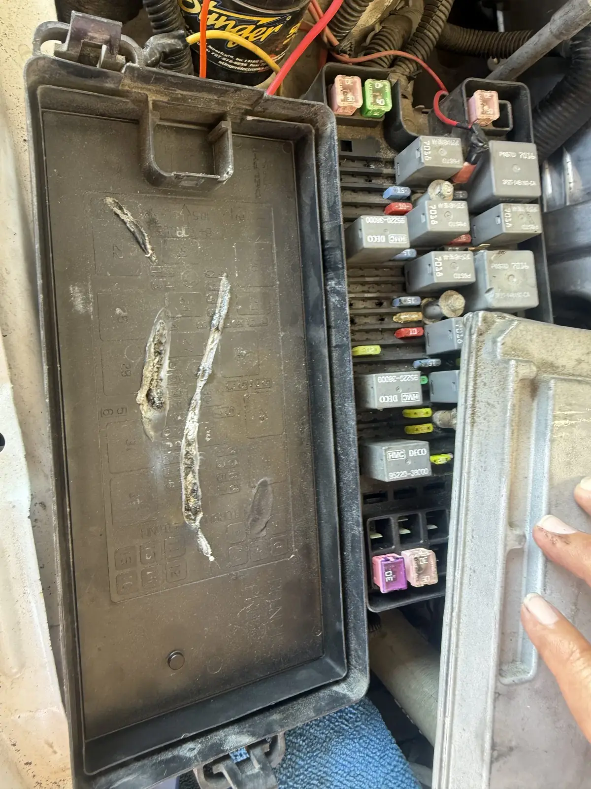 The corrosion track inside a fuse box lid.