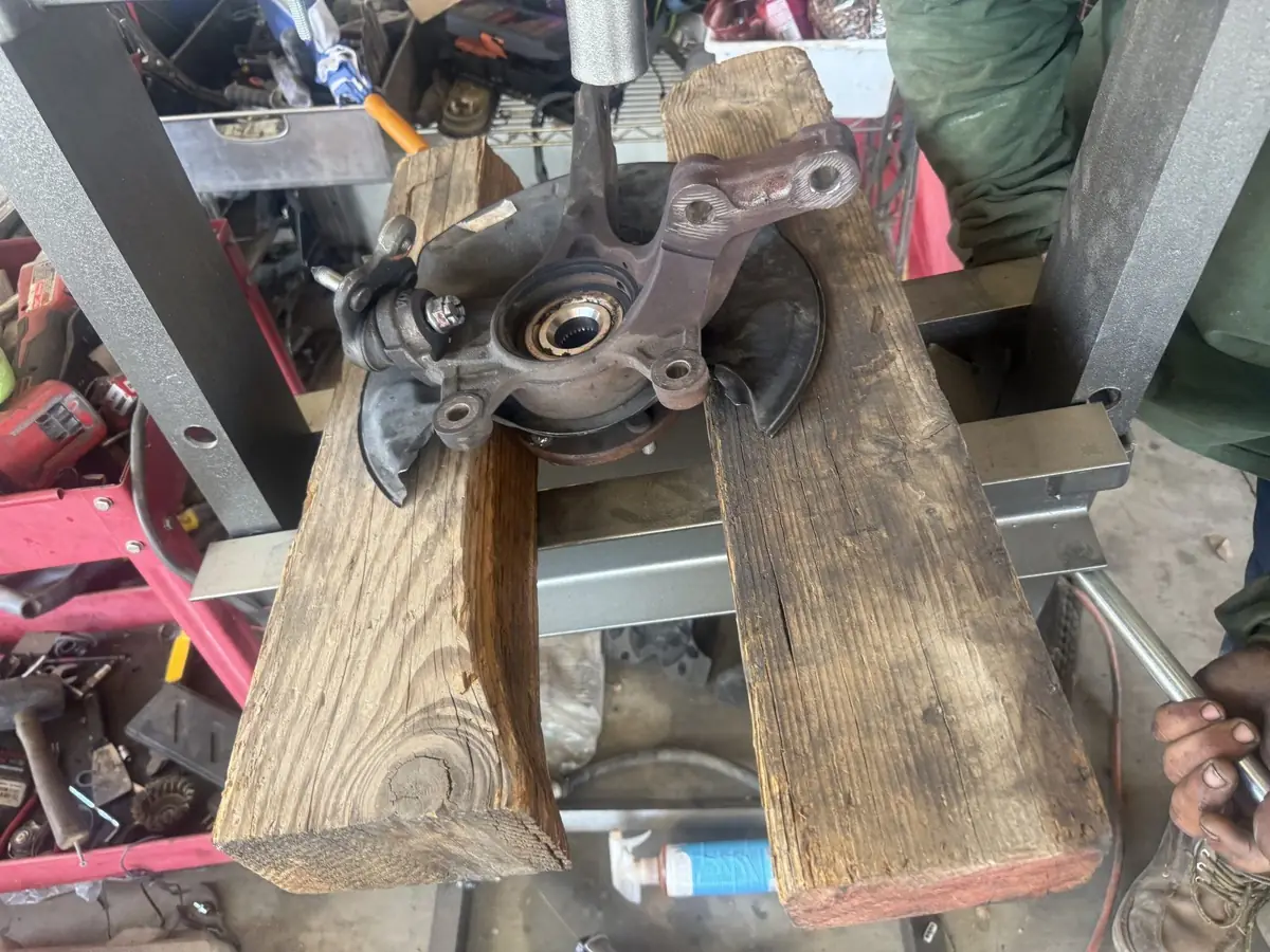 Steering knuckle and hub up on blocks.