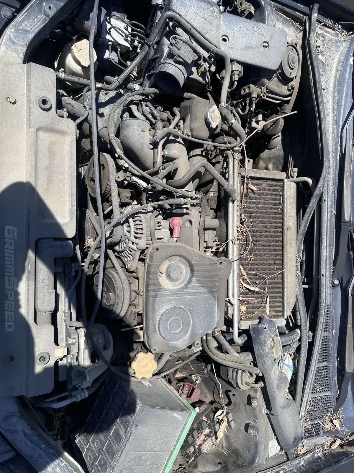 Aftermarket intake on a dusty boxer engine.