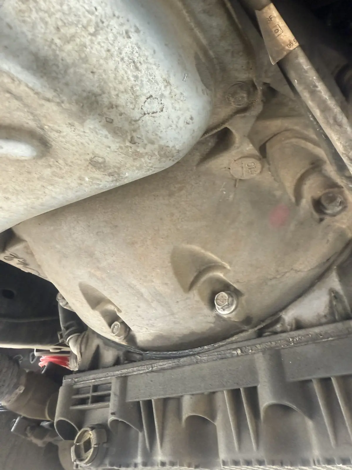 Transmission pan and crossmember on a driveway job.